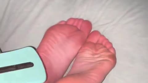 Tickling girlfriend feet with hairbrush