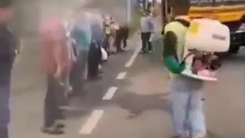Ecuado Sprays Down Passengers Before Boarding Bus