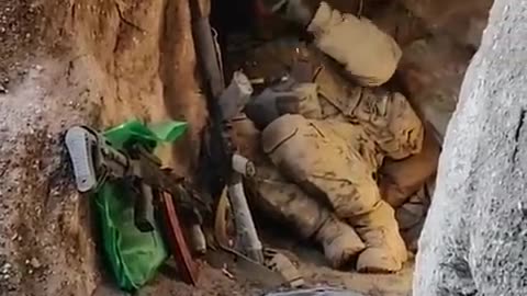 Ukrainian soldiers barely avoid Russian bomb as they hide in a trench.