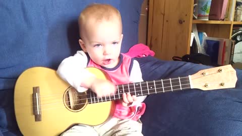 Baby Singing and Playing Ukulele.mp4
