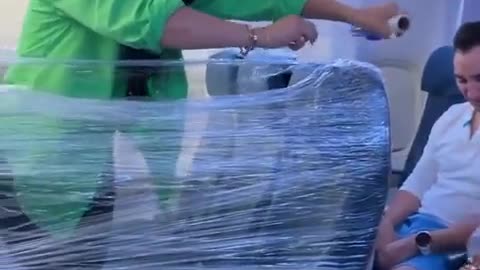 crazy woman makes clingfilm fort on plane