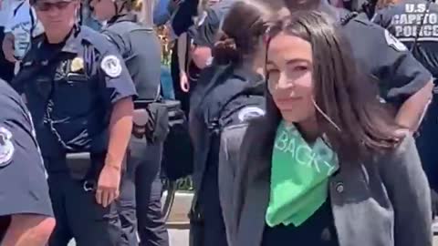 AOC was just escorted by police away from the Supreme Court.