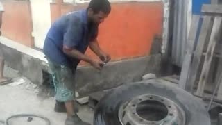 Man Inflates Tire with Fire and Pants Fall Down