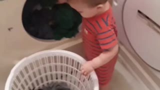 Helpful Little Boy Assists Mommy With The Laundry