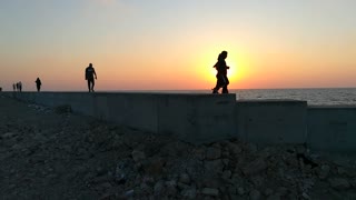 French Tourists Walks Along Side In Sunset Orange View