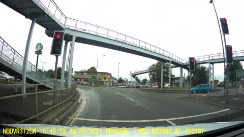 Oncoming Car Tipped to Two Wheels in Traffic