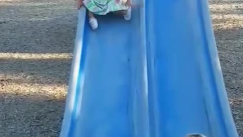 Collab copyright protection - baby girl tumbles down blue slide