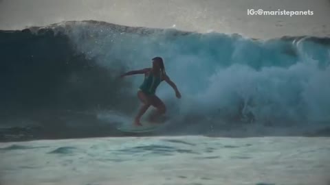 Music girl in green swimsuit surfer gets wiped out by wave