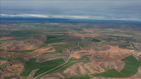 aerial view desert landscape with a road and green fields high altitude spain teruel province