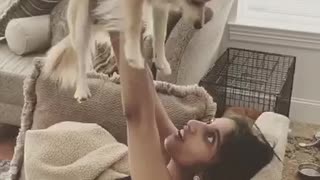 Girl uses dog as weight