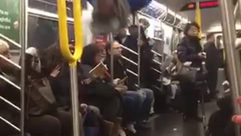 Guy in blue shirt back flip hanging from ceiling