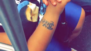 Girl on subway has bitch tattoo on arm