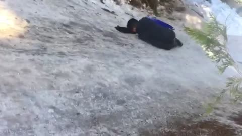 Guy on small blue sled falls off and hits head