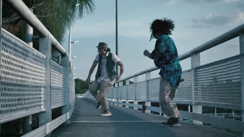 Dancing hip-hop on a pedestrian bridge