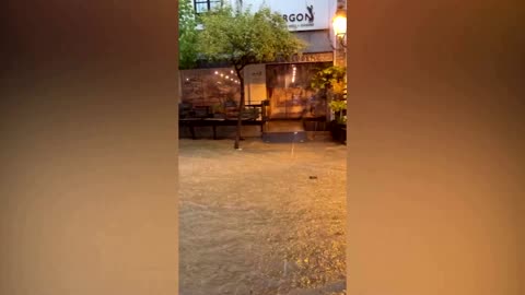 Tourists dine in flooded streets in Greece