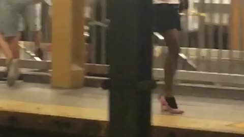 Person subway dancing red high heels splits platform