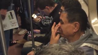 Man bald picking nose subway packed