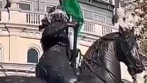 Protesters in London with Palestinian flag on a statue of King Charles I