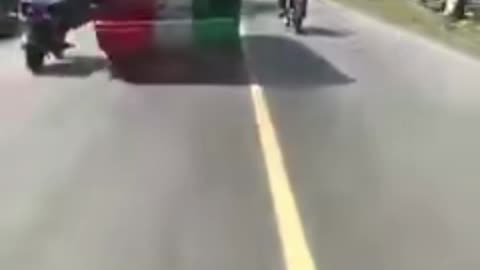 Car nudges motorbike driver crazy