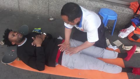 Luodong Massages Black SkateBoarder On Sidewalk
