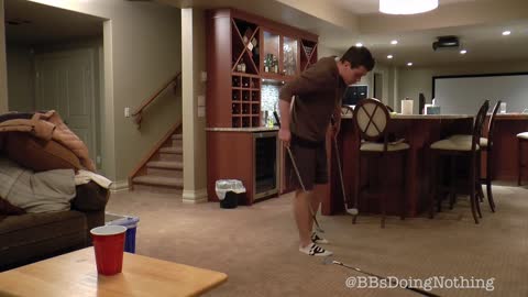 Epic trick shot using three golf clubs and a red cup
