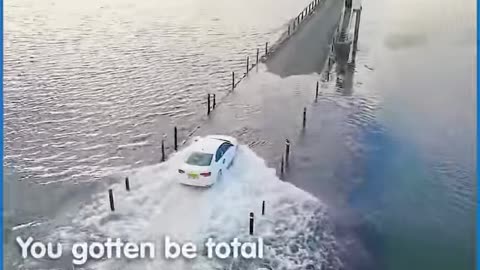 TAXI DRIVER STEERS THROUGH THE MID SEA