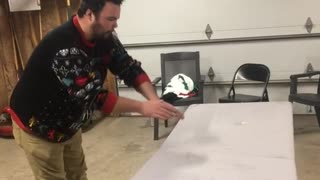Drunk guy jumps over foldable table, breaks table in half and falls down