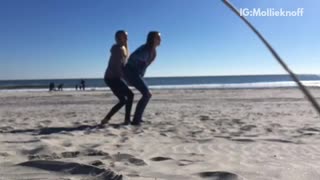 Girl trying to flip friend over faceplants