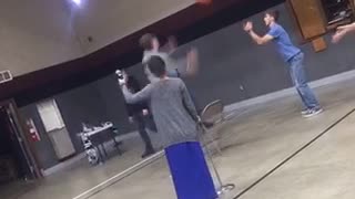 Guy jumps on chair to jump shot basketball fall