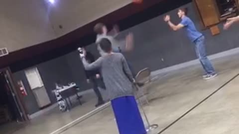 Guy jumps on chair to jump shot basketball fall