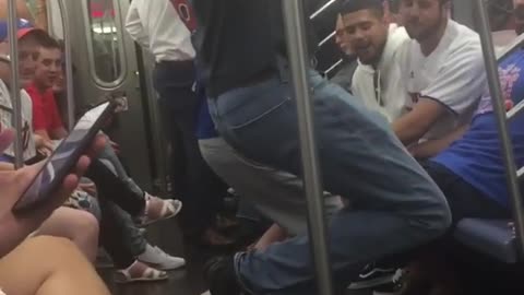 Two guys hanging from subway rail in train