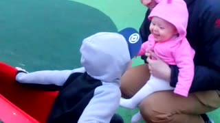 Baby girl giggles as she finds big brothers running around hilarious