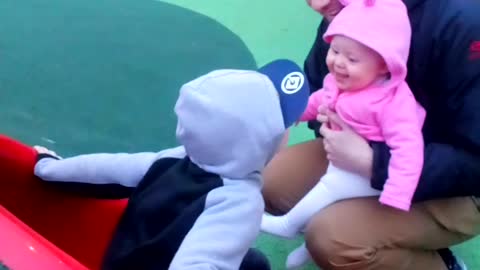 Baby girl giggles as she finds big brothers running around hilarious