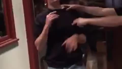 Guy white shirt slaps guy black shirt