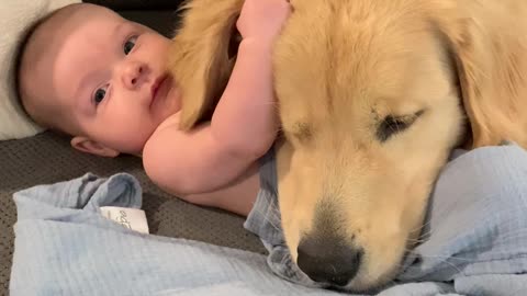 Baby And Dog Cuddling On The Couch