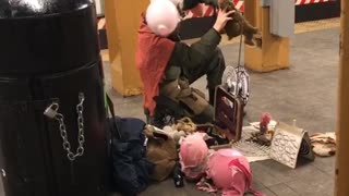 Scary singing subway guy with animal in pink costume and pink balloon tied to head