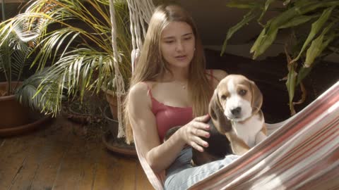 A Woman and Her Dog in a Hammock