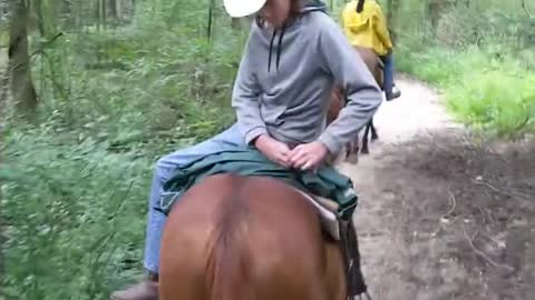 Bella - Joel tying raincoat behind saddle while trail riding at Waterloo - 13 Aug 2022