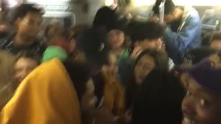 Crowded subway full of people all yell yeah