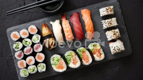 C:\Users\86134\rumble_utils\download\Sushi rolls set with salmon and tuna fish served on black stone