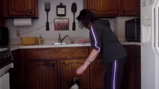 Woman Dribbles Jumping Dog That Loves Washing Dishes