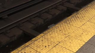 White pizza box on subway rail tracks