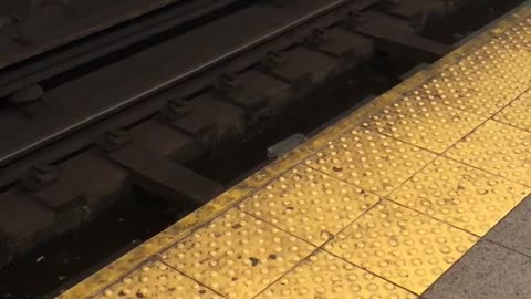 White pizza box on subway rail tracks