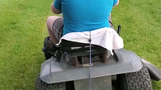 Boy rides lawnmower for the first time