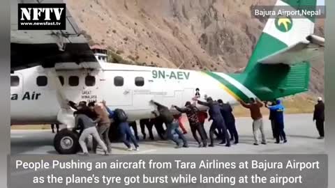 Passengers Pushing Tara Airlines plane at Bajura Airport Nepal