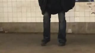 Old man singing on subway platform