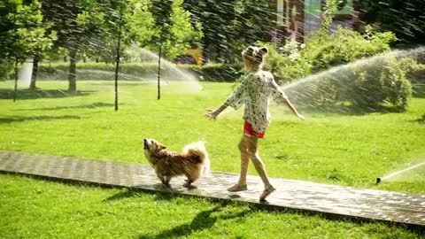 Girl and dog running in the park path