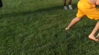 Guy blue shirt playing football and getting tackled