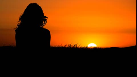 Beautiful landscape and a meditating girl on the background of the sunset. How beautiful it is!!!