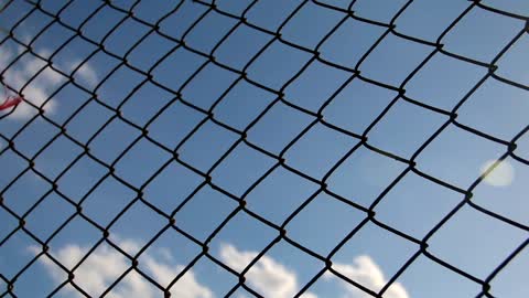 Metal mesh with blue sky in the background